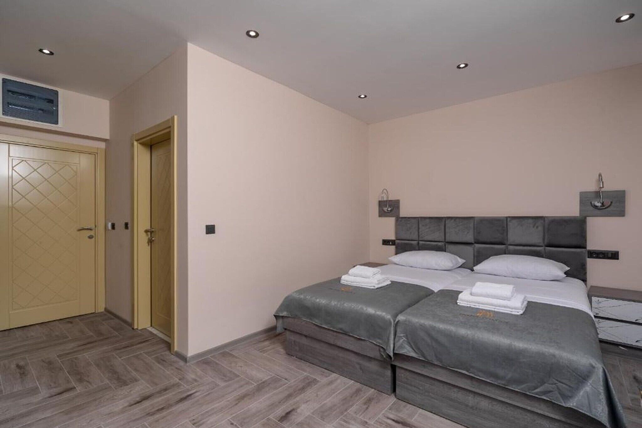 A bedroom with a double bed, a wardrobe, and a ceiling light.