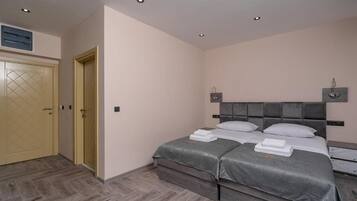 A bedroom with a double bed, a wardrobe, and a ceiling light.