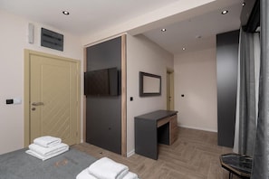 A hotel room with a bed, a desk, a TV, and a wardrobe. - Hotel D'Iman - Double Room with Sea View and Balcony (Dobra voda)