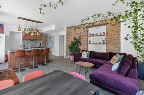 A modern living space with a kitchen, dining area, and seating area.