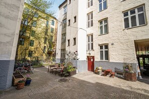 A courtyard with a seating area, potted plants, and a bicycle.