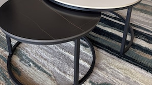 A living room with a sofa, a round coffee table, and a small potted plant. - The Lakeview Residence (Kinloch)