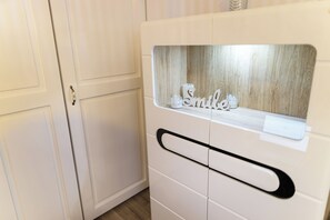 A white cabinet with a handle and a window displaying the word 'Smile'.
