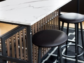 A bar area with a marble countertop and black stools. - 2 Mins from King St < > A Boutique Old Town Xcape (Alexandria)