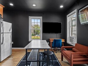 A modern kitchen with a marble countertop, a built-in oven, and a refrigerator. - 2 Mins from King St < > A Boutique Old Town Xcape (Alexandria)