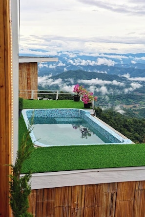 A swimming pool with a view of a mountainous landscape.