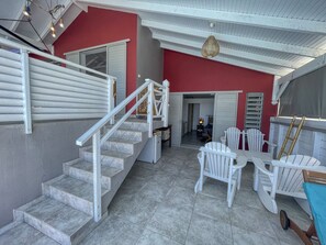A staircase leading to a second floor with a red wall and white railings. - Villa with Bungalow & Pool – Sleeps 10 (Saint-François)