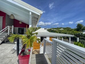 A coastal property with a covered outdoor area, a staircase, and a view of the sea. - Villa with Bungalow & Pool – Sleeps 10 (Saint-François)