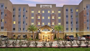 Un hôtel Staybridge Suites doté d’une entrée principale, de plusieurs étages et d’un espace de stationnement.