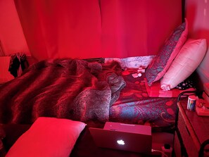 A bed with a laptop, pillows, and a blanket. - Bed room in a cosy appartement Eiffel Tower (Paris)