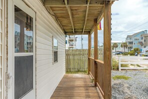 A wooden porch with a view of a residential area. - The Treasure Chest 2 - 2BR Ground Floor Unit!  Dog Friendly! Close Beach Access! (Surf City)