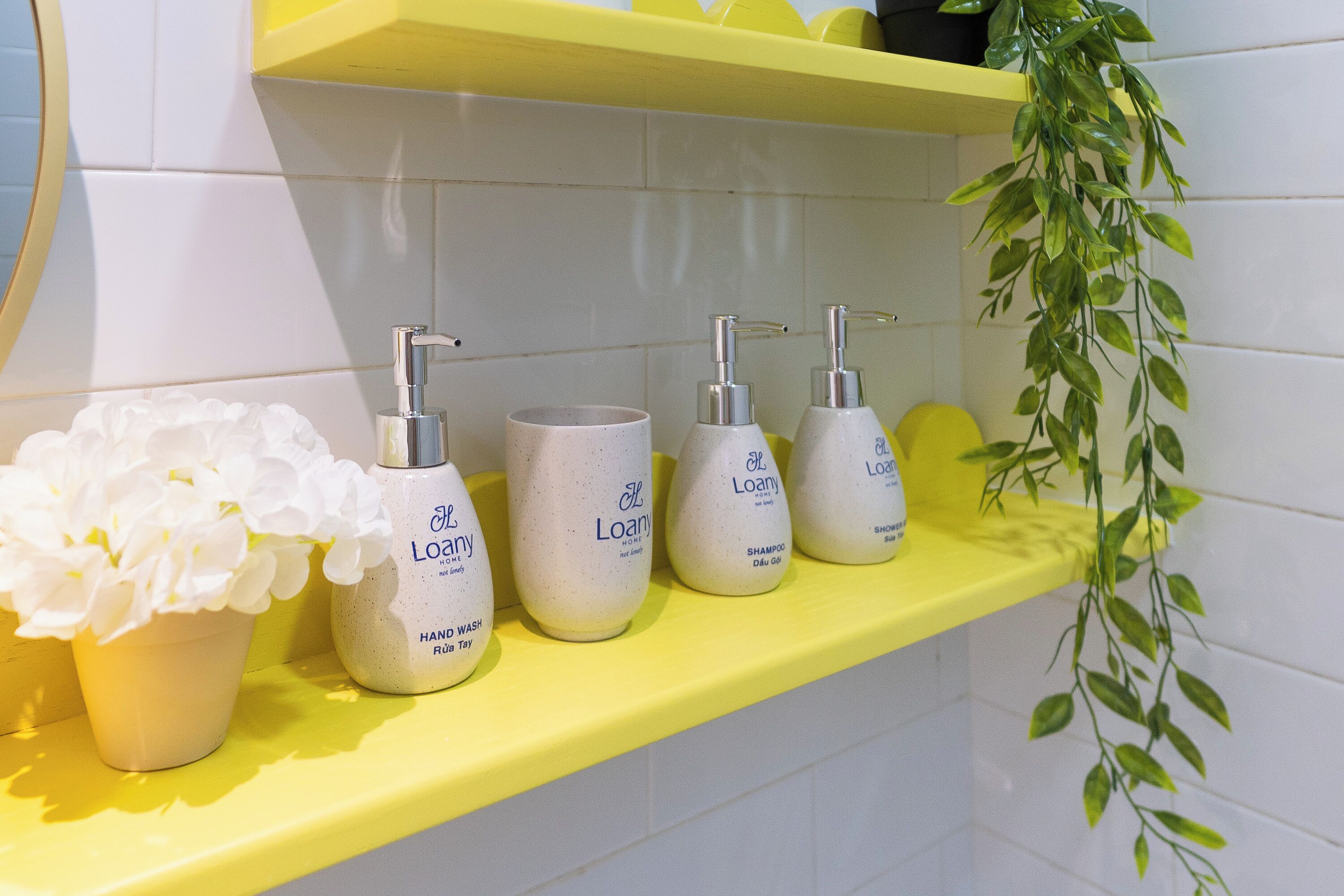 A bathroom shelf with toiletries including a hand wash, shampoo, and a shower bottle.