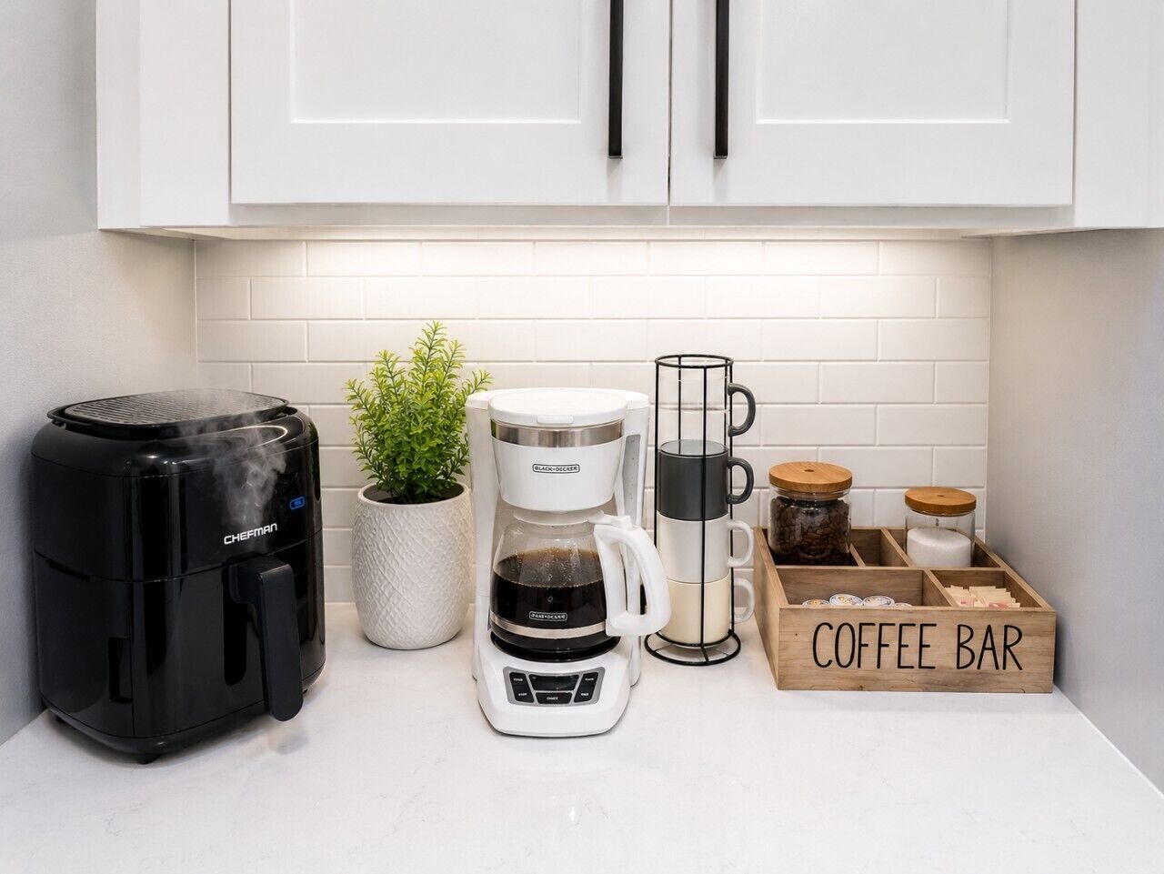 A kitchen with a coffee maker, a coffee machine, a coffee bar, and a plant.