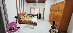 A bedroom with a bed, a wardrobe, a desk, and a chair. - Studio Apartment in East Legon central near A&C mall (Accra)