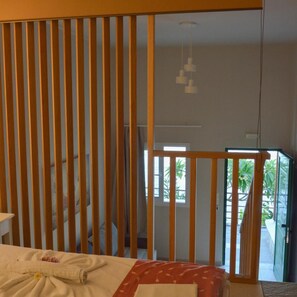 A hotel room with a bed, a window, and a view of the outside.