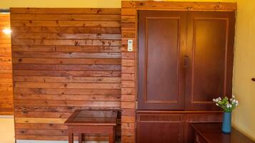 A wooden wall with a door and a small table.