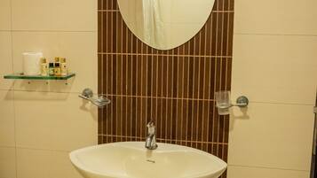 Ein Badezimmer mit Waschbecken, Spiegel und Handtuchhalter.
