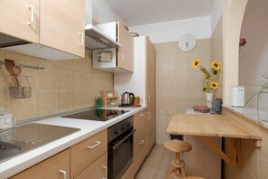 A compact kitchen with a sink, stove, and wooden countertop. - Sanità inside By Dimorra  (Naples)