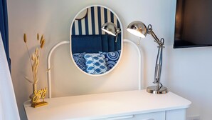 A white desk with a round mirror and a desk lamp. - bnbme - Al Jazi - 2BR (Dubai)