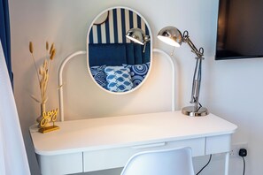 A white desk with a round mirror and a desk lamp. - bnbme - Al Jazi - 2BR (Dubai)