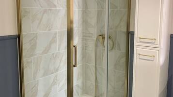 Shower, hair dryer, towels, toilet paper