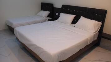 A double bed with a wooden frame and a headboard with a grid pattern.