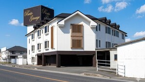A multi-story building with a large sign reading 'Punto Garage.'