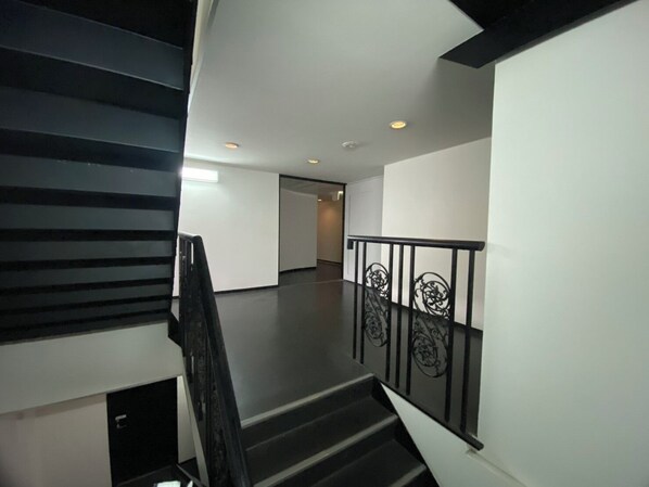 A staircase with a black railing and a modern interior design.