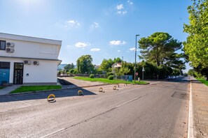 A street with a building on the left, a clear sky, and trees. - Alter 26 Urban Apartment With Free Parking (Koper)