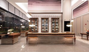 A modern reception area with a wooden reception desk, glass display cabinets, and a large abstract painting on the wall. - Mercure Shanghai Lujiazui Binjiang Center (Shanghai)