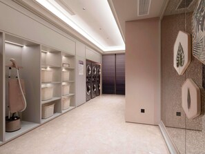 A hotel laundry room with shelves, baskets, and a drying rack. - Mercure Wuxi Tian'An Intelligent Park (Wuxi)