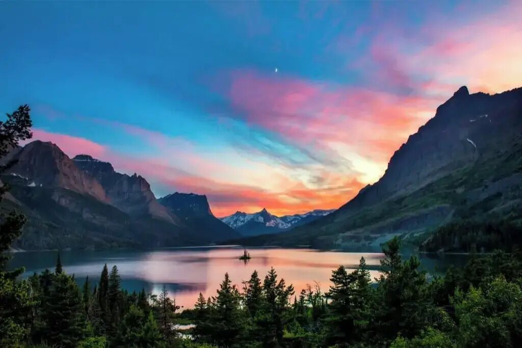 A mountainous landscape with a lake and forested area.
