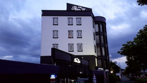 A hotel with a modern facade, multiple windows, and a sign indicating it is a hotel. - HOTEL PALETTE GOLD (Kurashiki)