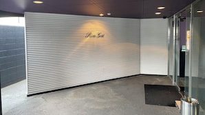 A modern interior with a metallic wall featuring the text 'Palette Gold'. - HOTEL PALETTE GOLD (Kurashiki)