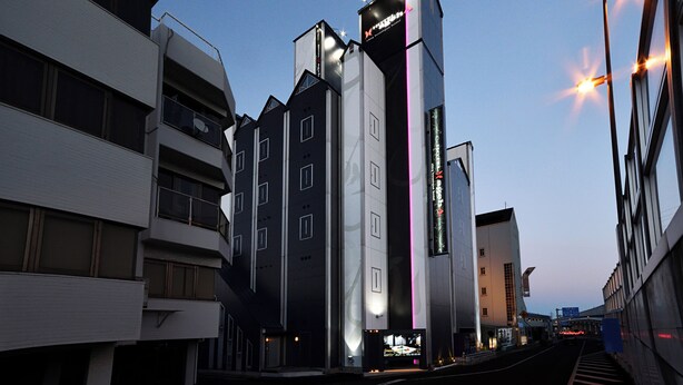 A modern building with a prominent sign for a hotel.