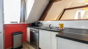 A compact kitchen with a dishwasher, a toaster, and a sink. - T2 élégant devant la mairie - calme - centre (Arras)