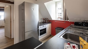 A kitchen with a refrigerator, oven, and sink. - T2 élégant devant la mairie - calme - centre (Arras)