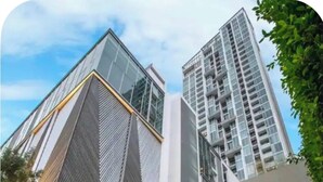 A modern building with a prominent entrance and a sign reading 'HYDE SUKHUMVIT 11'. - Hyde 2BR Luxury Suite Near BTS Nana (Bangkok)