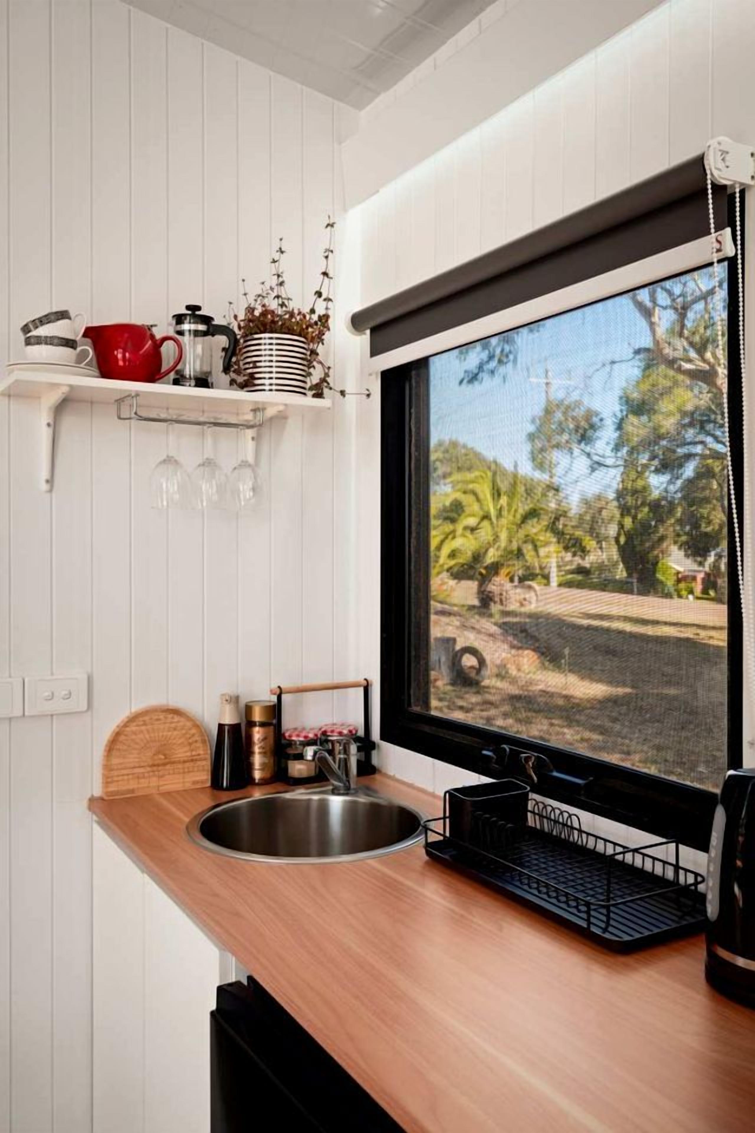 A kitchen with a window, a sink, and a countertop.