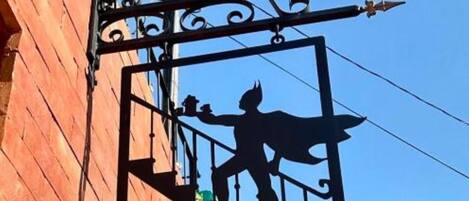A sign for 'Bat N' Breakfast' with a silhouette of a bat and a cat.