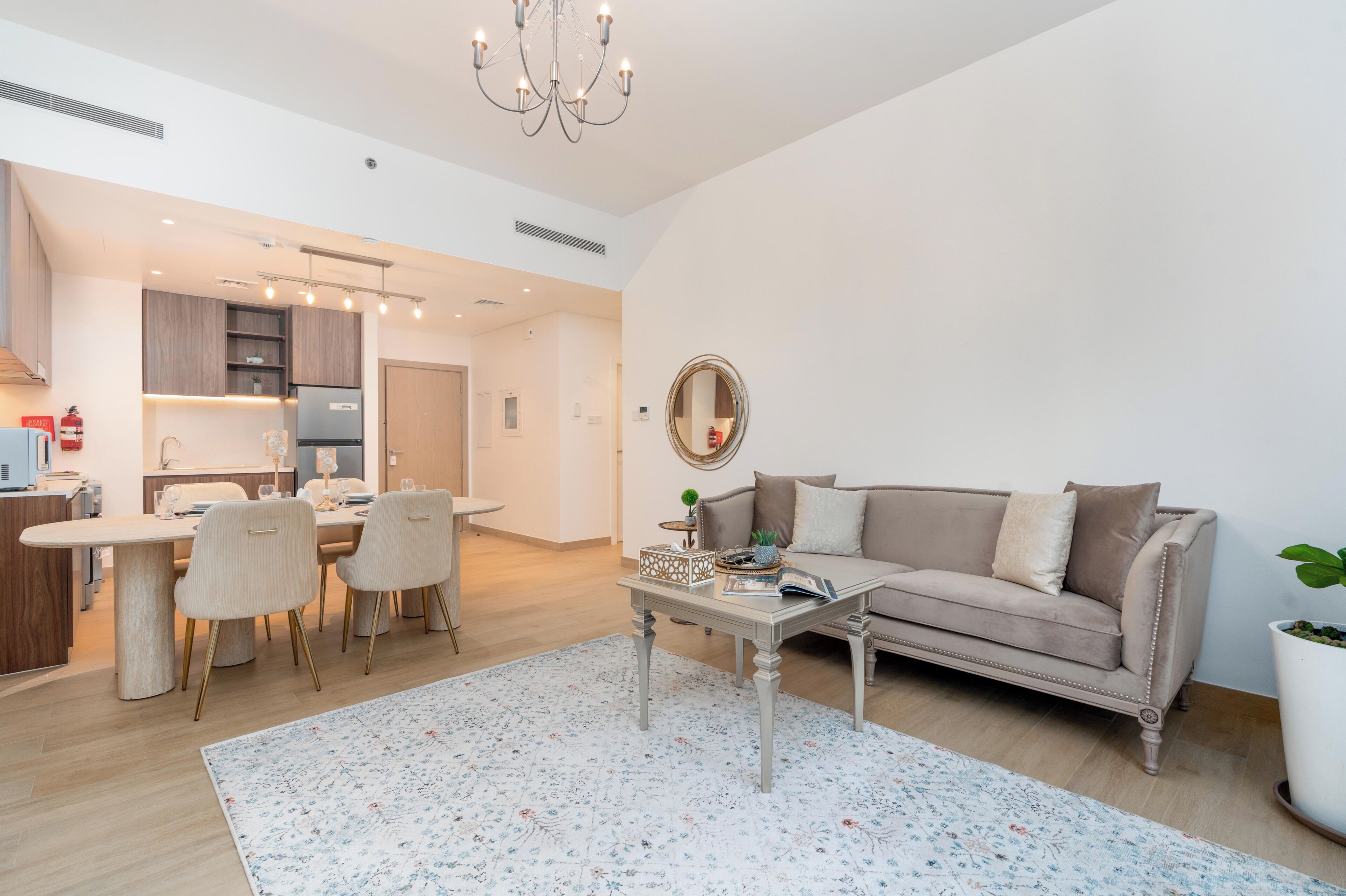 A modern living room with a sofa, coffee table, and dining area.