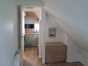 A compact kitchen with a microwave, sink, and cabinets. - A beautiful 2-room apartment facing the ocean (Piriac-sur-Mer)