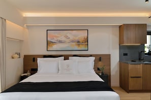 A hotel room with a bed, a painting, a nightstand, a vase, and a view of the outside.