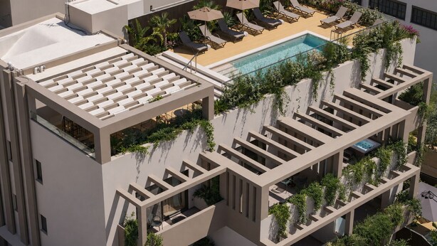 A rooftop pool area with lounge chairs and umbrellas, surrounded by greenery and modern architecture.