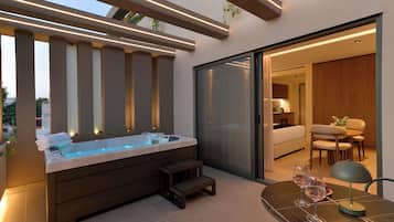 A modern outdoor hot tub area with a glass door leading to a dining space.