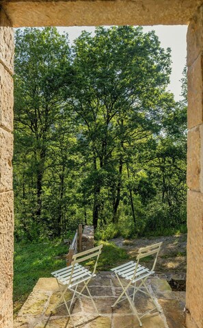 A stone bench with a view of a forest. - Designed and renovated villa with mountain views (Selaya)