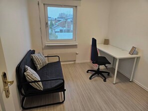 A small, furnished room with a bed, a desk, and a chair. - Unic House, Feeling Calmness in Malmö City (Malmö)