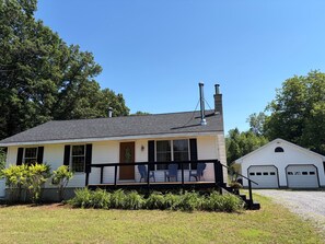 A single-story house with a porch, a chimney, and a garage.