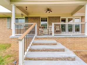 A residential property with a front porch, a staircase, and a brick exterior. - Beautiful Home on Mountainous Tree Farm (Newland)