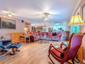 A living room with a sofa, chairs, a coffee table, and a fireplace. - Beautiful Home on Mountainous Tree Farm (Newland)